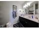 The bathroom features a dual sink vanity, white walls and diamond patterned floor mat at 30186 W Pinchot Ave, Buckeye, AZ 85396
