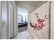 This bathroom has a shower with curtain featuring red accents and access to the main bedroom at 30186 W Pinchot Ave, Buckeye, AZ 85396