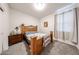 Bedroom with a wooden bed frame, nightstand, and neutral-toned walls at 30186 W Pinchot Ave, Buckeye, AZ 85396
