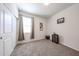 This bedroom features a neutral carpet, a window with beige curtains and a closet with sliding doors at 30186 W Pinchot Ave, Buckeye, AZ 85396