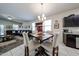 Open-concept dining area adjacent to living room, featuring updated chandelier and bar area at 30186 W Pinchot Ave, Buckeye, AZ 85396