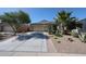 Charming single-story home with a well-manicured front yard, desert plants, and a two-car garage at 30186 W Pinchot Ave, Buckeye, AZ 85396