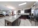 Expansive kitchen with granite island, stainless steel appliances, and open layout flowing into dining and living areas at 30186 W Pinchot Ave, Buckeye, AZ 85396