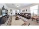 Spacious living room with a large sectional sofa, decorative rug, and access to the backyard at 30186 W Pinchot Ave, Buckeye, AZ 85396