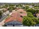 Charming home aerial view featuring a terracotta roof, mature trees, a lush landscape, and a serene residential neighborhood at 3146 E Maryland Ave, Phoenix, AZ 85016