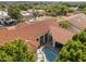 Aerial view of a gorgeous home featuring a terracotta roof, a private pool, and mature trees in a beautiful neighborhood at 3146 E Maryland Ave, Phoenix, AZ 85016
