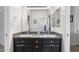 Bathroom featuring double granite vanity, large mirror, and view into the shower at 3146 E Maryland Ave, Phoenix, AZ 85016