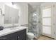 Bathroom with marble vanity, framed shower, and an exterior door at 3146 E Maryland Ave, Phoenix, AZ 85016