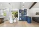 Dining area adjacent to kitchen features a bar, backyard views and modern lighting at 3146 E Maryland Ave, Phoenix, AZ 85016