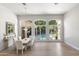 Bright dining room with views of the pool, wood floors, and contemporary white furnishings at 3146 E Maryland Ave, Phoenix, AZ 85016
