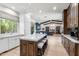 Spacious kitchen featuring a large island with seating, wood floors, and an open layout at 3146 E Maryland Ave, Phoenix, AZ 85016