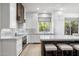 Modern kitchen with white cabinetry, stone countertops, and stainless steel appliances, offering both style and functionality at 3146 E Maryland Ave, Phoenix, AZ 85016