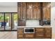 Modern kitchen features custom wood cabinetry, a built-in microwave, and access to the pool area at 3146 E Maryland Ave, Phoenix, AZ 85016