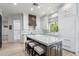 Bright kitchen features an island with seating, white cabinets and a wooden range hood at 3146 E Maryland Ave, Phoenix, AZ 85016