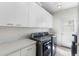 Well-lit laundry room with modern washer and dryer, ample cabinet space, and a utility sink at 3146 E Maryland Ave, Phoenix, AZ 85016