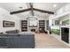 Cozy living room with a stone fireplace, built-in bookshelves, and vaulted ceilings with wooden beams at 3146 E Maryland Ave, Phoenix, AZ 85016
