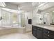 Bright main bathroom featuring a separate shower, large soaking tub, and granite countertops at 3146 E Maryland Ave, Phoenix, AZ 85016