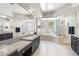 Luxurious main bathroom displaying granite countertops, glass block accents, and a soaking tub at 3146 E Maryland Ave, Phoenix, AZ 85016
