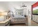Bright main bedroom showcasing white walls, light wood floors, and a cozy sitting area at 3146 E Maryland Ave, Phoenix, AZ 85016