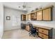 Office space with built-in wood cabinets, ceiling fan, and light hardwood floors at 3146 E Maryland Ave, Phoenix, AZ 85016
