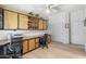 Office area with custom wood cabinets and drawers, ceiling fan, and light hardwood floors at 3146 E Maryland Ave, Phoenix, AZ 85016