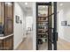 Walk-in pantry features custom shelving, a decorative door, and convenient access from the kitchen at 3146 E Maryland Ave, Phoenix, AZ 85016