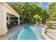 Refreshing pool with blue tile, rock waterfall feature, and shaded patio area at 3146 E Maryland Ave, Phoenix, AZ 85016