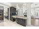 Bathroom vanity area with granite counters, dark wood cabinets, and a walk-in closet at 3146 E Maryland Ave, Phoenix, AZ 85016