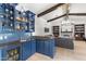 Entertainment space with a wet bar featuring blue tile backsplash, custom cabinetry, and backyard views at 3146 E Maryland Ave, Phoenix, AZ 85016
