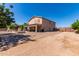 Expansive backyard featuring a brick patio, covered seating, and clear blue skies at 31700 N Sunflower Way, San Tan Valley, AZ 85143