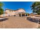 Expansive backyard featuring a brick patio, covered seating, and clear blue skies at 31700 N Sunflower Way, San Tan Valley, AZ 85143