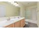 Bright bathroom featuring double sinks, light wood cabinets, and shower-tub combination, offering functionality and style at 31700 N Sunflower Way, San Tan Valley, AZ 85143