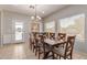 Well-lit dining room with a large wooden table and eight chairs, perfect for Gathering meals and entertaining at 31700 N Sunflower Way, San Tan Valley, AZ 85143
