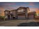 Charming two-story home with a two-car garage and beautiful landscaping at sunset at 31700 N Sunflower Way, San Tan Valley, AZ 85143