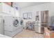 Modern laundry room with stainless steel appliances and ample storage space at 31700 N Sunflower Way, San Tan Valley, AZ 85143
