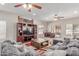 Comfortable living room featuring a large sectional sofa, entertainment center, and ceiling fan at 31700 N Sunflower Way, San Tan Valley, AZ 85143