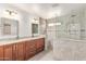 Elegant bathroom featuring double sinks, granite countertops, tiled shower, and providing a spa-like experience at 31700 N Sunflower Way, San Tan Valley, AZ 85143