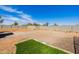 Spacious backyard featuring low-maintenance gravel, privacy walls, and a small area of artificial turf at 38106 N 2Nd Ln, Phoenix, AZ 85086