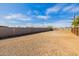 Expansive backyard with potential for customization, featuring a gravel surface and a sturdy block fence for privacy at 38106 N 2Nd Ln, Phoenix, AZ 85086
