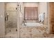 Bathroom with standalone tub, glass shower, and shuttered window at 38106 N 2Nd Ln, Phoenix, AZ 85086