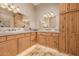 Double sink bathroom featuring tile floors and wooden cabinets at 38106 N 2Nd Ln, Phoenix, AZ 85086