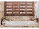 Standalone tub with tile backdrop and shuttered window providing natural light at 38106 N 2Nd Ln, Phoenix, AZ 85086