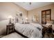 Comfortable bedroom with decorative mirror, bedside table and shuttered window at 38106 N 2Nd Ln, Phoenix, AZ 85086