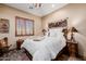Bedroom featuring a rustic wood bed frame, shutters and accent decorations at 38106 N 2Nd Ln, Phoenix, AZ 85086