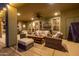 Inviting covered patio boasts cozy seating, ceiling fan, and a mounted TV for ultimate outdoor relaxation at 38106 N 2Nd Ln, Phoenix, AZ 85086