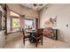 Breakfast nook featuring wood table, decorative accent cabinet, view of patio, and tile floors at 38106 N 2Nd Ln, Phoenix, AZ 85086