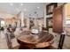 Open concept living area featuring kitchen, stone fireplace, and hardwood dining table at 38106 N 2Nd Ln, Phoenix, AZ 85086