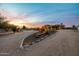Expansive desert landscaping and warm exterior lighting highlight this beautiful home at sunset at 38106 N 2Nd Ln, Phoenix, AZ 85086