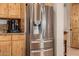 Stainless steel refrigerator complements the knotty alder cabinets and countertops in this well-appointed kitchen at 38106 N 2Nd Ln, Phoenix, AZ 85086