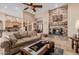 Spacious living room featuring a stone fireplace, sofa, and open floor plan at 38106 N 2Nd Ln, Phoenix, AZ 85086